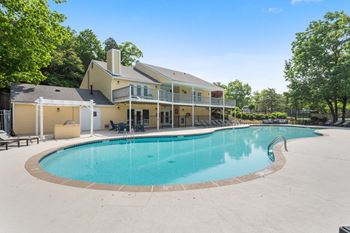 a resort style pool with a house in the background